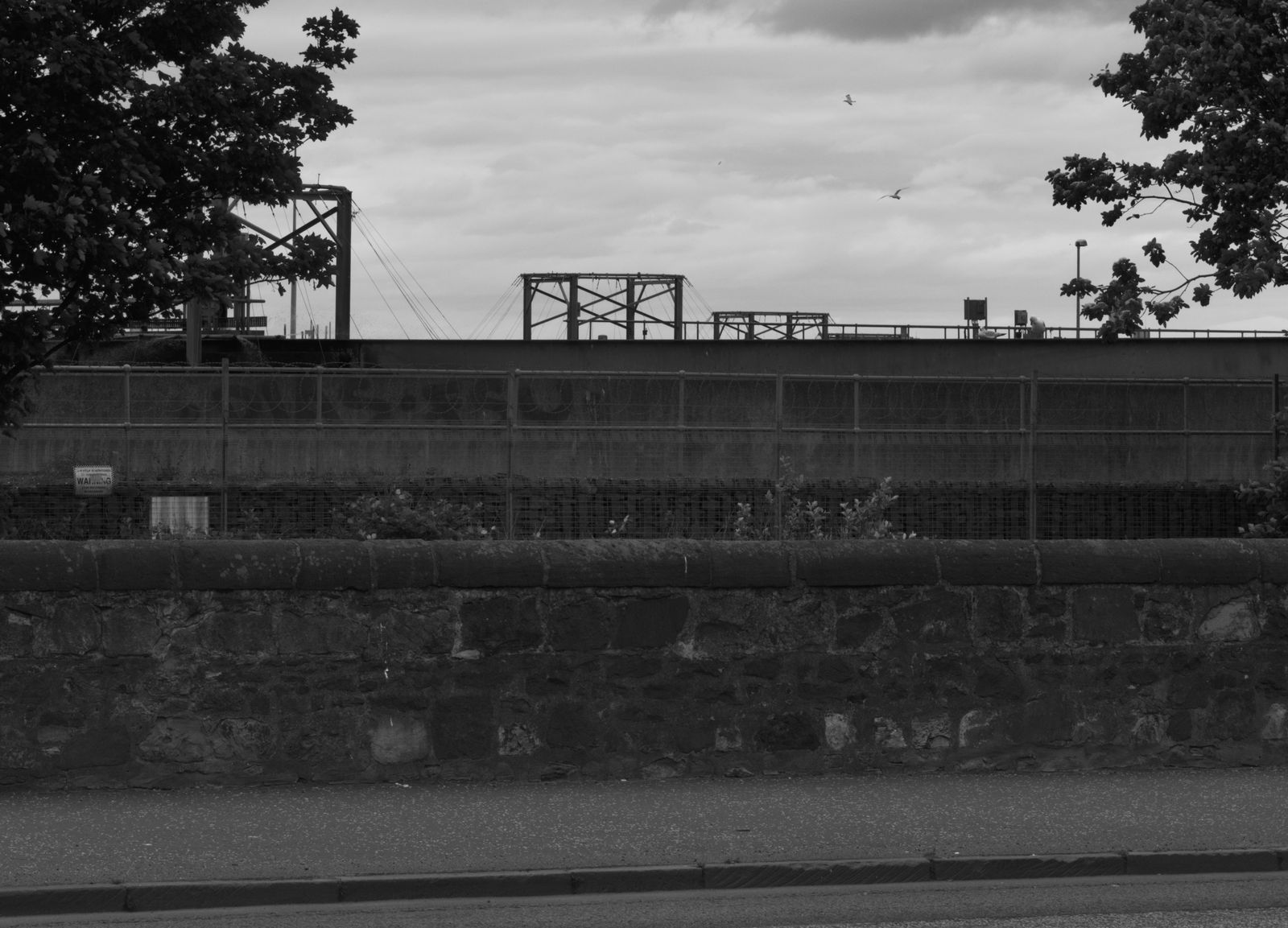 Photograph of a sign or marking out of context, left behind in an edgeland