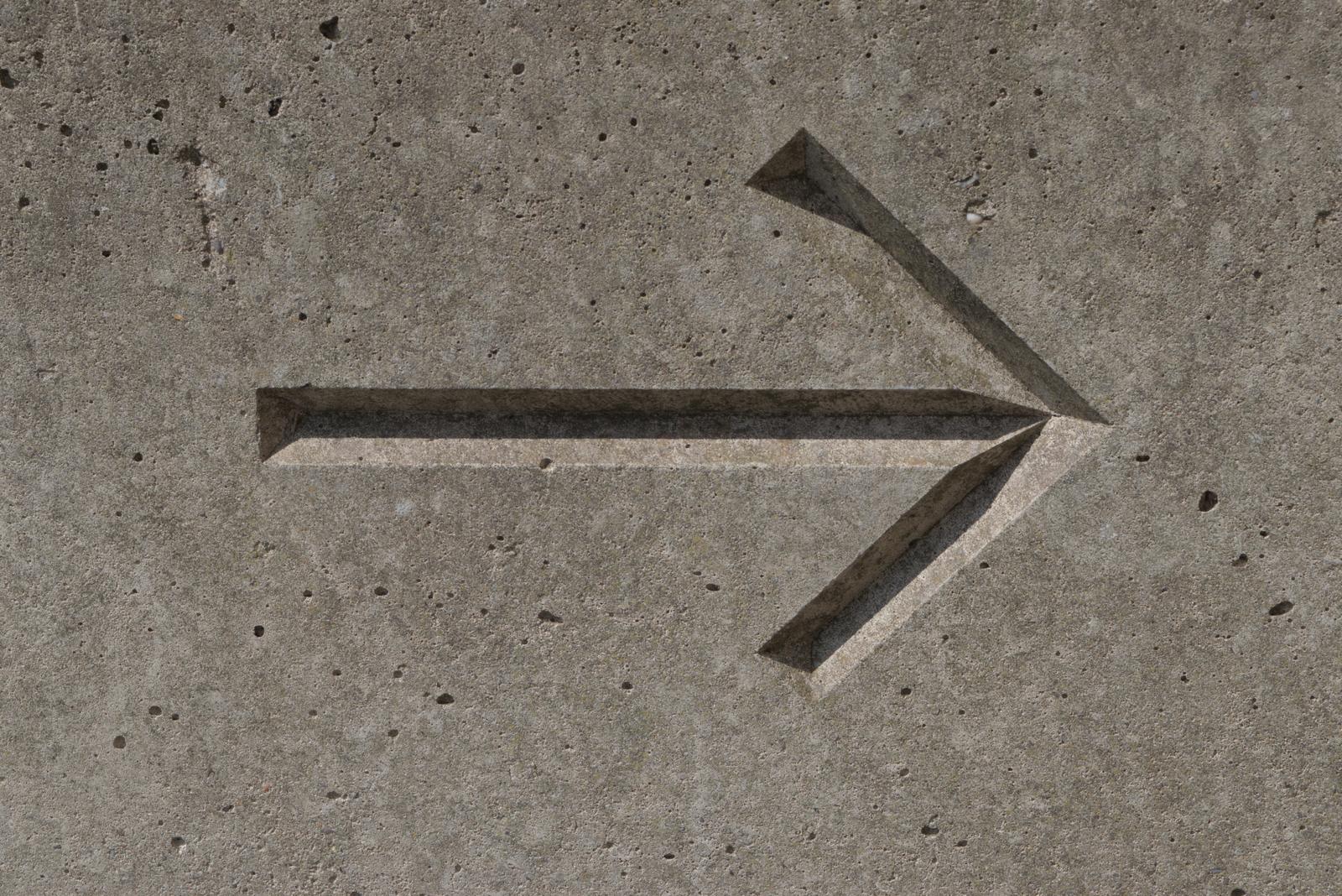 Photograph of a sign or marking out of context, left behind in an edgeland